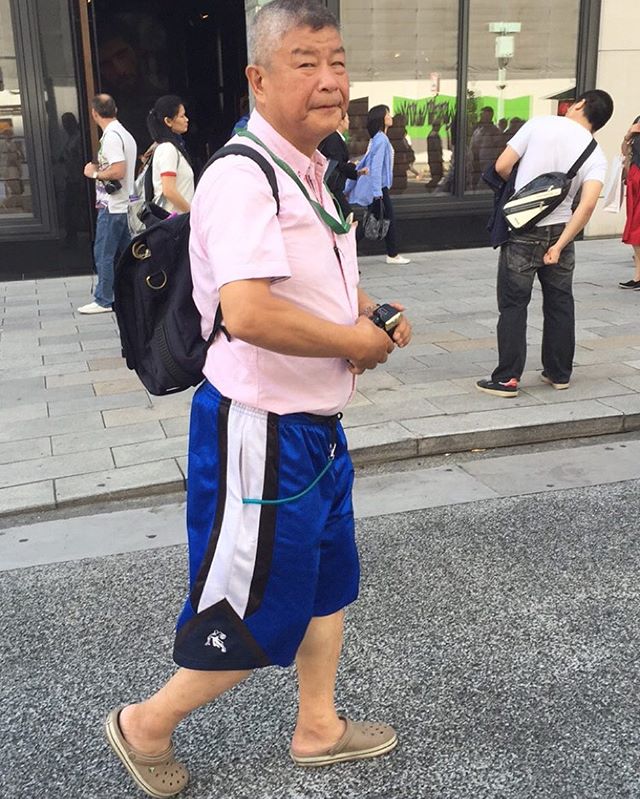 a ss button up shirt tucked in to athletic shorts is true athleisure