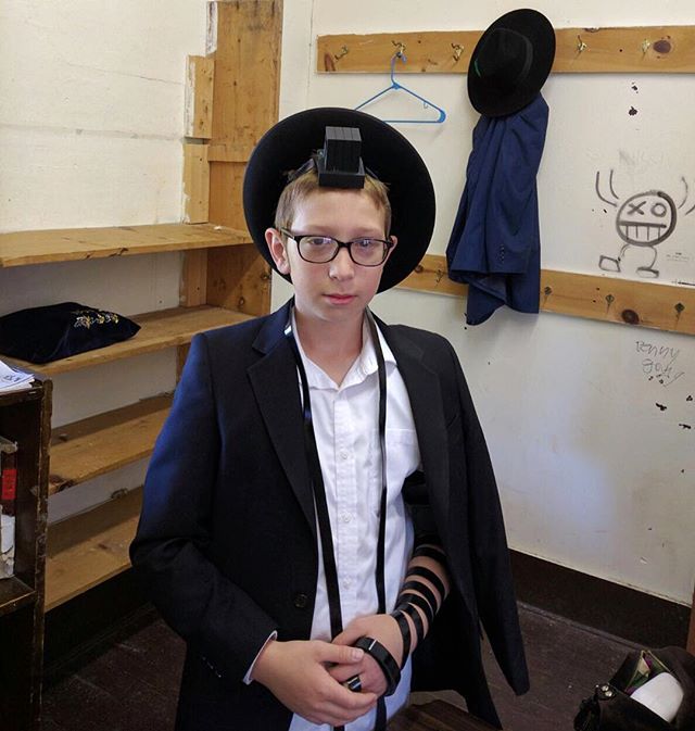 Mazel Tov! My nephew Chaim Lemel started putting on tefillin!

A Jewish boy, upon reaching his 13th birthday, is regarded as a full fledged Jew. He then becomes a "Bar Mitzvah," meaning that he is begins to keep and perform all the laws and customs of the Jewish people. One of them is is Tefillin. 
It is customary to initiate the boy into the practice of donning the Tefillin 2-3 months before the actual date of his Bar Mitzvah.
When purchasing a pair of Tefillin, care should be taken to buy it from a dependable store in order to be sure the Tefillin are hand-written by a duly qualified Scribe (sofer). Those not produced in conformity with the specified requirements of Tefillin, may not be used.
Tefillin is donned Sunday through Friday only.
Tefillin are worn during the morning prayers. However, if for some reason it was impossible to do so in the morning, Tefillin may still be put on later in the day, but not after sunset